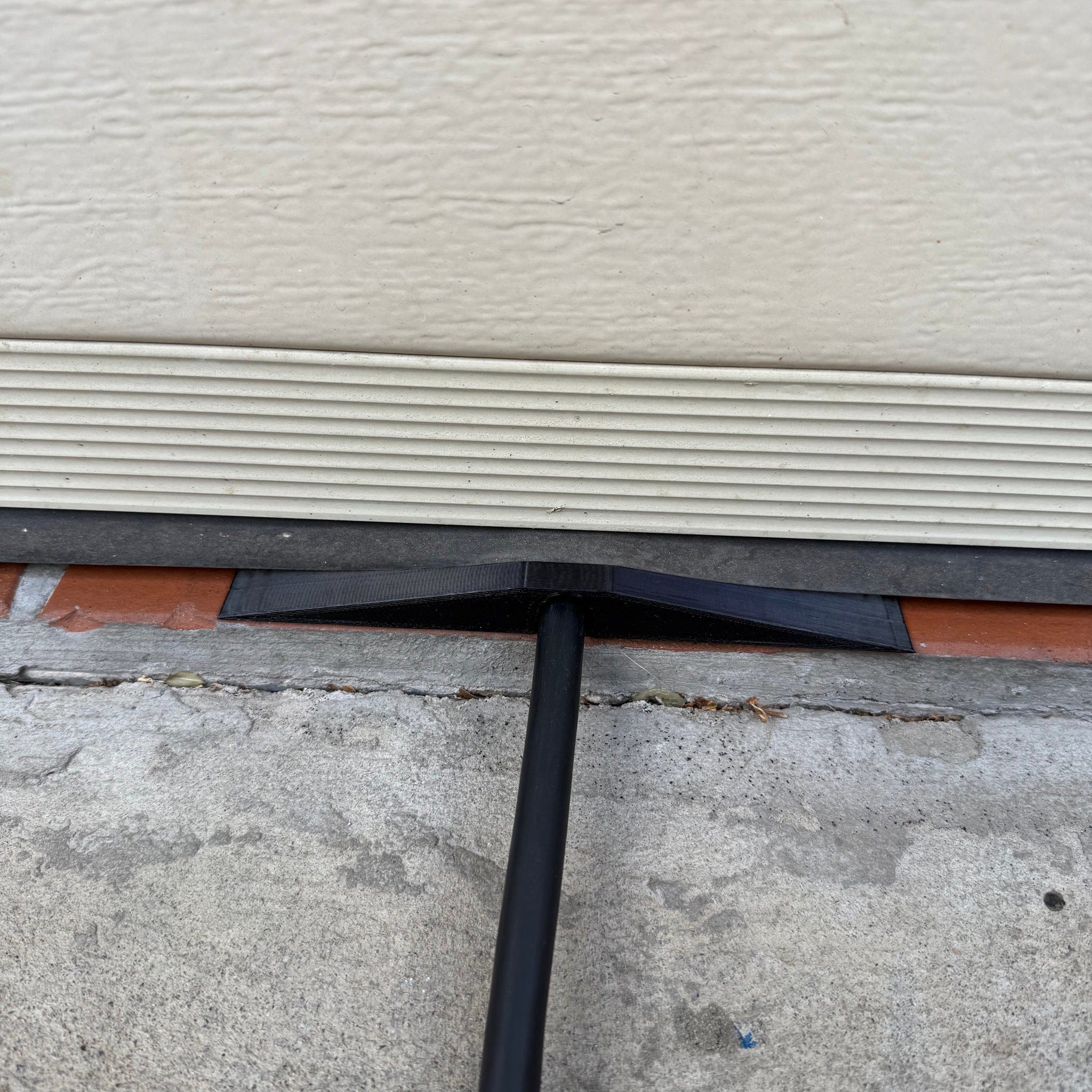 Center-wedge EV charging cable garage door pass-through protector